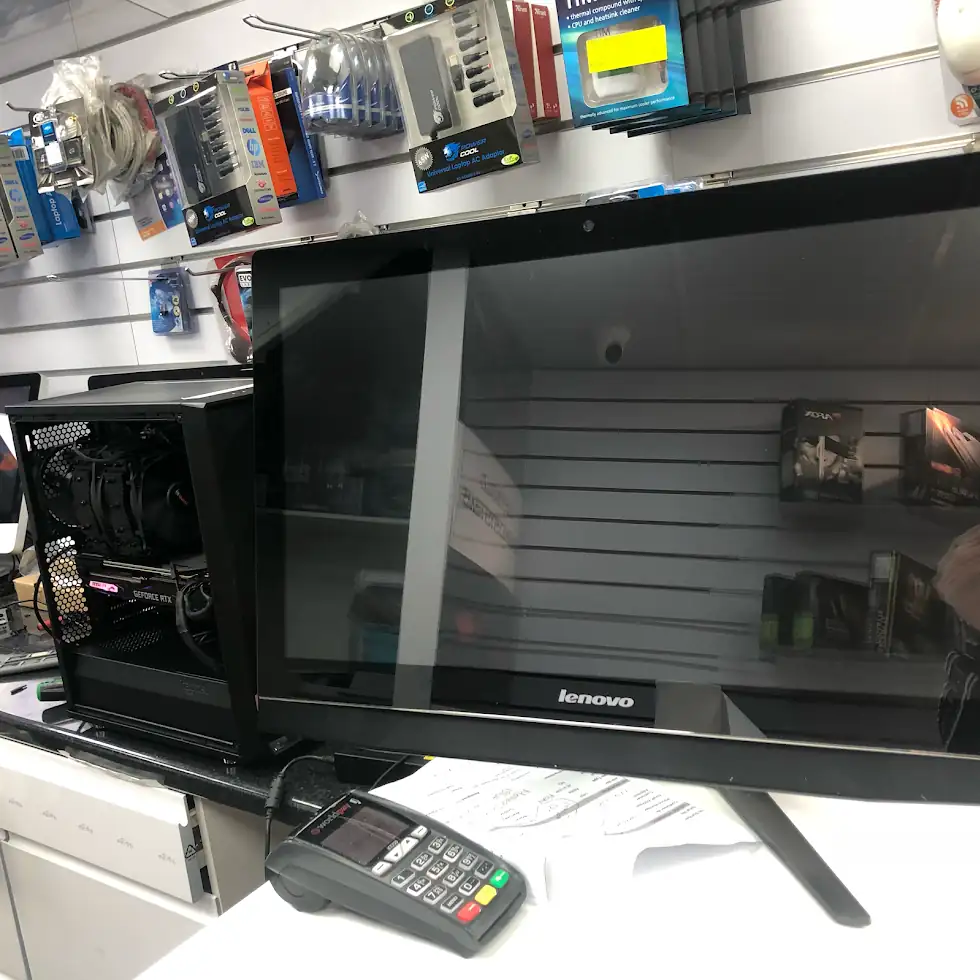 Workshop bench with Lenovo all-in-one and custom RTX desktop being serviced